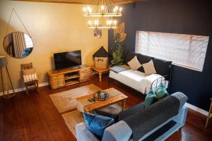 a living room with a couch and a tv at Modern Farm in Lichtenburg