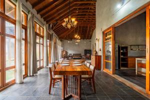 a dining room with a wooden table and chairs at Elite Villa - By Purvish Hospitalities in Bangalore +20 photos