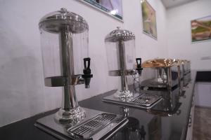 two blenders sitting on top of a counter at Ramjay Corbet Jungle Resort in Kotdwāra