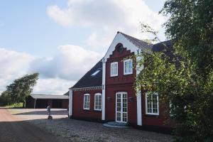 a red house with a black roof at Blåbjerg Barn in Tønder