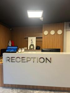 a reception desk in an office with a reputation sign at Frezya Family Hotel in Istanbul