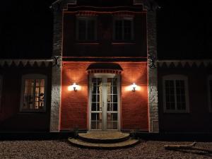 a house with a white door at night at Blåbjerg Barn in Tønder