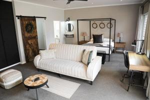 a living room with a couch and a bed at Modern Farm in Lichtenburg +167 photos