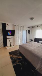 a bedroom with a bed and a large window at Palma Spaces in Pretoria