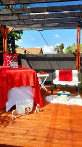 a bedroom with a red and white bed on a wooden floor at Palma Spaces in Pretoria +5 photos