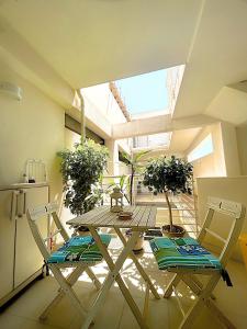 a kitchen with a table and two chairs and a refrigerator at A casa del nonno Jack in Letojanni +13 photos