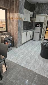 a kitchen with white appliances and a tile floor at Maison Jaspe in Brazzaville +13 photos