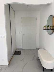 a white room with a stool and a mirror at Relax & work à Frespech 3 chambres 6 personnes in Frespech +27 photos