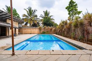 a swimming pool in the backyard of a house at Elite Villa - By Purvish Hospitalities in Bangalore