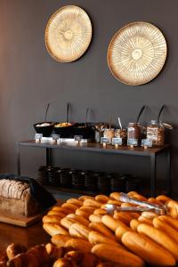 a table topped with lots of different types of bread at Brouwersdam Stay in Ouddorp