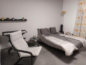 a bedroom with a bed and a chair and a table at Traumhaus in der Eifel in Hellenthal