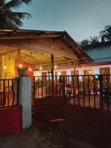 a house with a porch with a fence at Vino lanka in Trincomalee