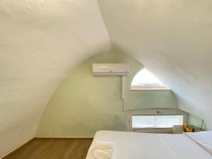 a small bedroom with a bed and a window at Corso Suite Gallipoli in Gallipoli