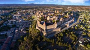 an aerial view of a city with a castle at Comme une évidence in Carcassonne