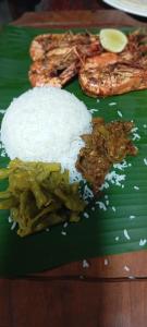 a green plate with rice and vegetables on a table at Vino lanka in Trincomalee +18 photos