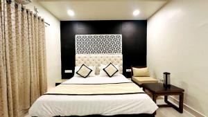 a bedroom with a large bed with a black wall at Abu Inn, Mount Abu - The Luxury Boutique Stay in Mount Ābu
