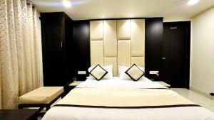 a bedroom with a large bed and a chair at Abu Inn, Mount Abu - The Luxury Boutique Stay in Mount Ābu