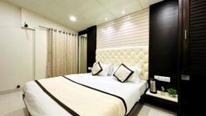 a bedroom with a large bed with two pillows at Abu Inn, Mount Abu - The Luxury Boutique Stay in Mount Ābu +55 photos