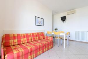 a living room with a couch and a table at Sunbeach Apartments in Lignano Sabbiadoro