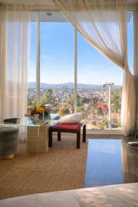 a bedroom with a large window with a view of a city at Amazing View From Los Fuertes in Puebla