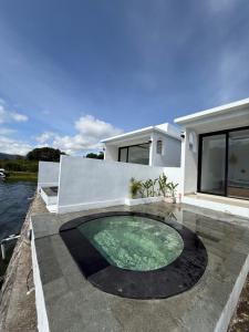 a house with a swimming pool next to the water at Uma Danu Villas Kintamani in Kubupenlokan