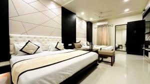 a hotel room with a large bed and a desk at Abu Inn, Mount Abu - The Luxury Boutique Stay in Mount Ābu