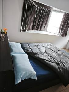 a bed in a room with a window and a bed sidx sidx sidx at TM Room For Rent in Pattaya