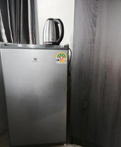 a refrigerator with a tea kettle on top of it at TM Room For Rent in Pattaya