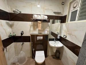 a bathroom with a toilet and a sink at The VP Residency Towerrs in Tiruttani +69 photos