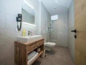 a bathroom with a sink and a toilet at Pension Kohler in Fügen