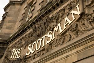 a sign on the side of a building at The Scotsman Hotel in Edinburgh
