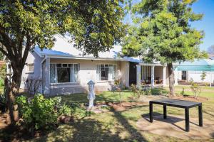 a house with a black table in the yard at Modern Farm in Lichtenburg