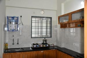 a kitchen with a sink and a stove at Elegant Beach View Flat , Bheemili in Bhīmunipatnam