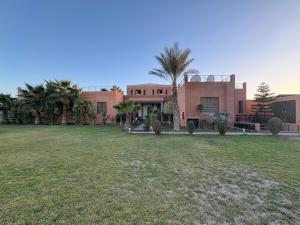 a large house with a yard in front of it at Villa Sofia And Spa in Marrakesh