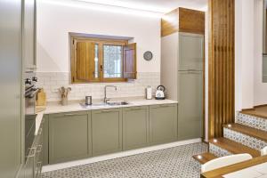 a kitchen with green cabinets and a sink at Casa Vicky in Città di Castello +29 photos