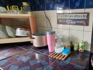 a kitchen counter with two trash cans and other items at Cassa Bonda Single Studio in Kampong Bakat +2 photos