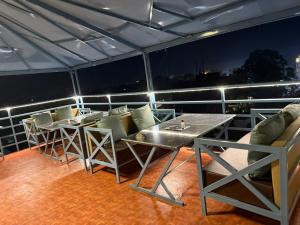 a balcony with a table and chairs on a ship at Hotel The Rajputana Ranthambore in Sawāi Mādhopur
