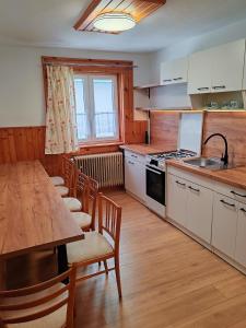 a kitchen with a table and chairs and a counter top at ZorHouse Ždiar in Ždiar