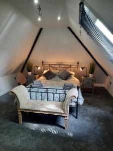 a bedroom with a large bed in a attic at The Barn at Creech View in Wareham
