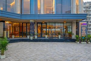 a large building with a lot of windows and plants at Sterling Avante Chandigarh Mohali in Mohali