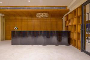 a large black table in a room with wooden walls at Sterling Avante Chandigarh Mohali in Mohali