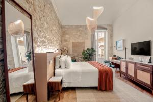 a bedroom with a large bed and a mirror at COOL DREAMS Luxury Rooms in Syracuse +205 photos