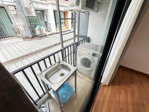 a balcony with a washing machine and a sink at Msthouse in Ban Bang Phun +83 photos