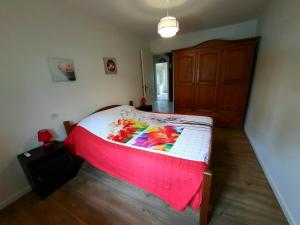 a bedroom with a bed with a colorful blanket on it at Gîte de Maurin campagne in Marguestau +6 photos
