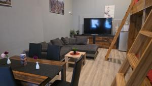 a living room with a couch and a flat screen tv at Flensburg City - 24h in Flensburg
