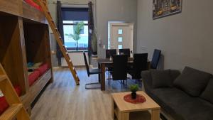 a living room with a couch and a table at Flensburg City - 24h in Flensburg
