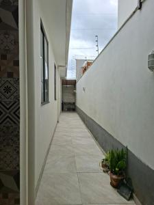 an empty hallway of a building with plants on it at Casa Tranquila em Diamantina in Diamantina