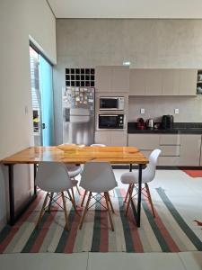 a kitchen with a wooden table and four chairs at Casa Tranquila em Diamantina in Diamantina