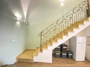 a staircase with two trash cans under the stairs at Corso Suite Gallipoli in Gallipoli