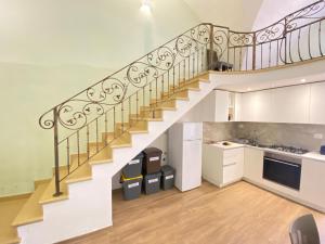 a kitchen with a staircase in a house at Corso Suite Gallipoli in Gallipoli +45 photos